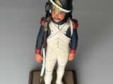 statue of a toy soldier with a red and black hat and a black and white uniform