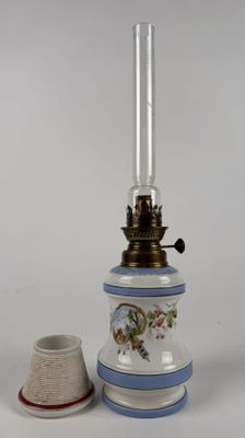 a small lamp that is sitting next to a small cup