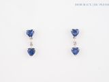 a pair of blue sapphire and diamond earrings on a white background