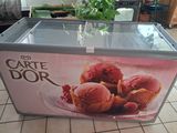 a cart with ice cream inside of it on a tiled floor