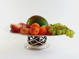 a plate of fruit that is sitting on a table