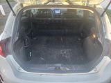 the back of a car with its trunk open and luggage in the trunk