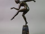 bronze statue of a boy on a marble base