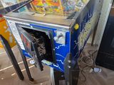 a pinball machine sitting on the floor in a room