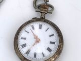 a close up of a pocket watch on a chain