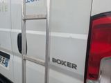 a ladder that is attached to the back of a white truck
