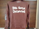 a mannequin wearing a brown hoodie with the words still social distancing printed on it