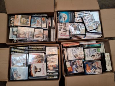 Plusieurs boîtes de DVD sont empilées les unes sur les autres.