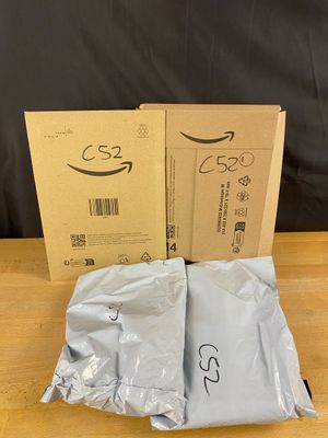 two boxes of amazon ' s new products are sitting on a table