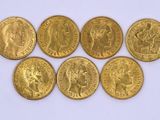 six gold sovereigns of different sizes and shapes