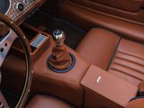 a car dashboard with a gear stick and a steering wheel