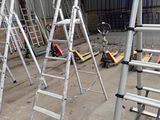 many ladders that are sitting in a warehouse