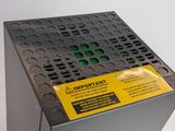 a close up of a metal box with a yellow label on it