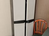 a refrigerator and a chair in the corner of a room
