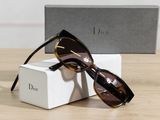 christian dior sunglasses in box and box on wooden table