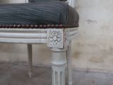 a close up of a chair with a cushion on it
