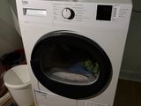 an image of a washing machine in the corner of a room