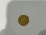 a gold coin sitting on top of a white table