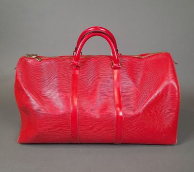 a red duffel bag sitting on top of a table