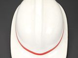 a white hard hat with a red stripe on it