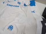 a white and blue soccer uniform on a table