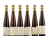 six bottles of wine are lined up in a row