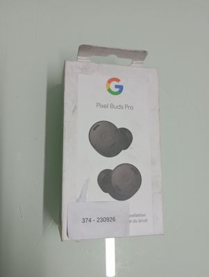 a box with a pair of ear buds sitting on top of it