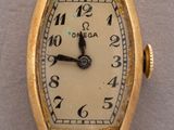 an image of a gold wrist watch with roman numerals