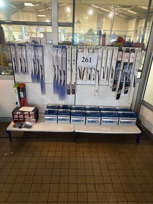 a display of pens and pencils on a shelf in a store