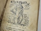 un vieux livre sur lequel figure le dessin d'une femme