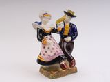 a figurine of a man and a woman sitting on top of a table