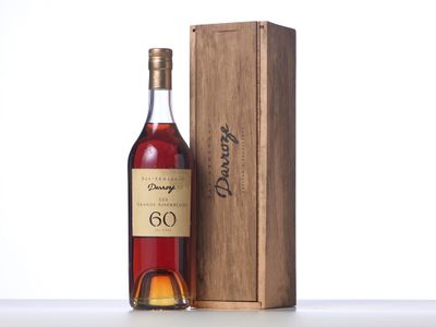 a bottle of wine sitting next to a wooden box