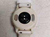 a close up of a white watch on a table