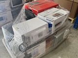 many boxes of electronic equipment on the floor in a warehouse