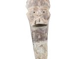 an image of a wooden sculpture of a head on a stand