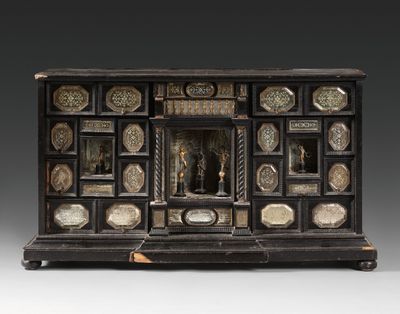 a black and gold cabinet with ornate carvings on the front