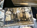 many old photos of a group of people on a table