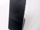 a cell phone that is sitting on top of a stand