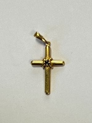 une petite croix en or sur un fond blanc