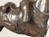 a statue of a horse with a saddle on it ' s back