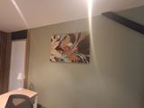 a painting on the wall above a desk in a room