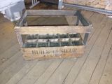 a wooden crate that has a bunch of glass inside of it