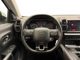 the interior of a car with a steering wheel and dashboard controls
