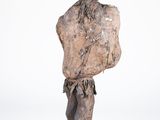 statue of a man standing on a square base with his hands on his hips