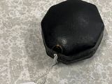 a small black bag with a tag attached to it