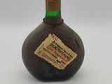 a small bottle with a label on it sitting on a table