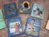 several children ' s books are lined up on a table