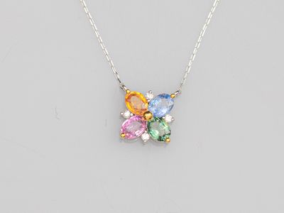 a close up of a necklace with multi colored stones on a chain
