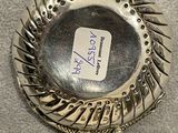 a silver plate with spikes on it on a table