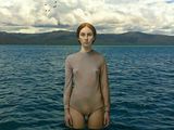 painting of a woman standing in the middle of a body of water with birds flying overhead